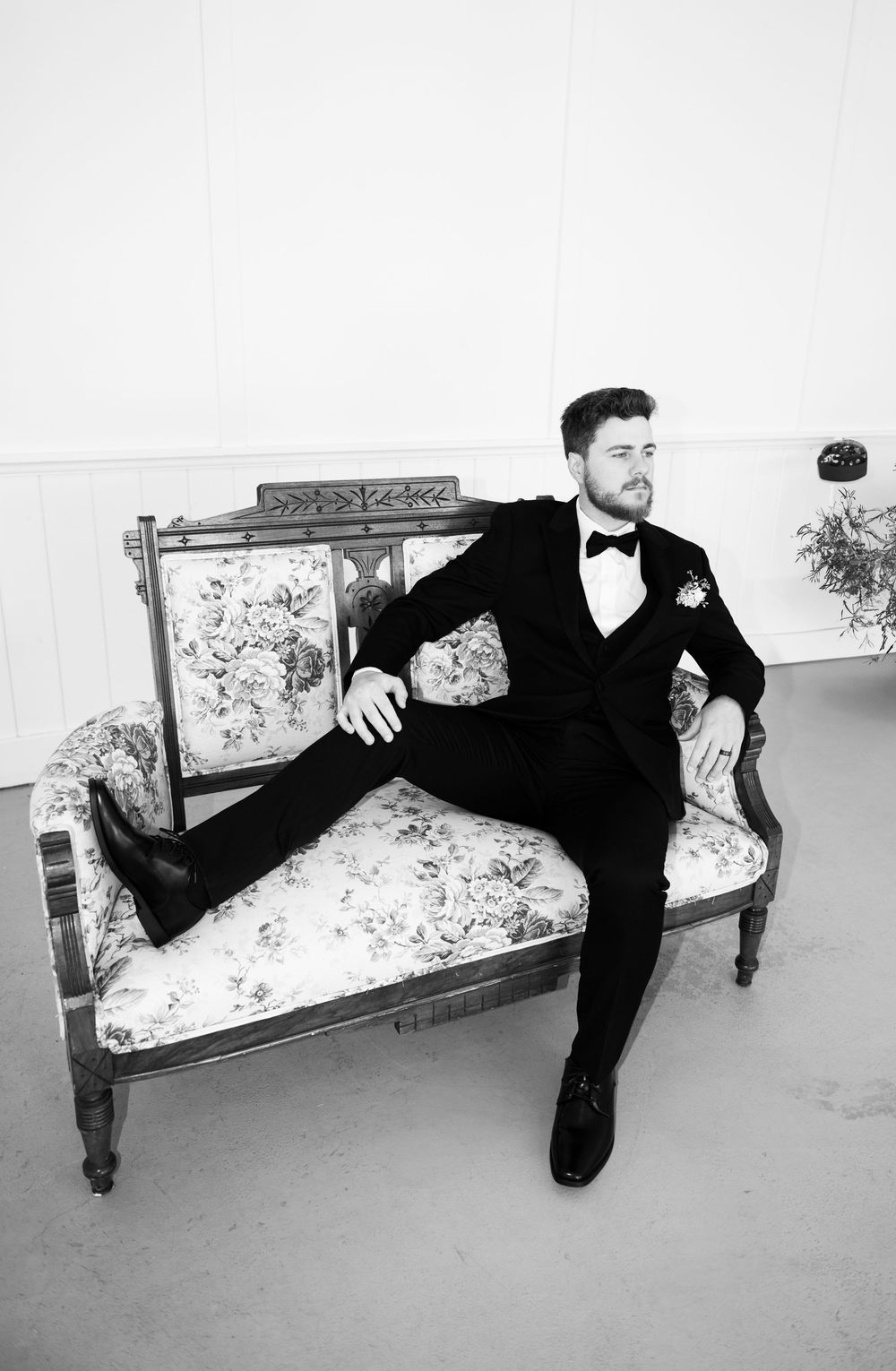 Black and white photos showing dramatic poses on an antique floral bench in formal wear.
