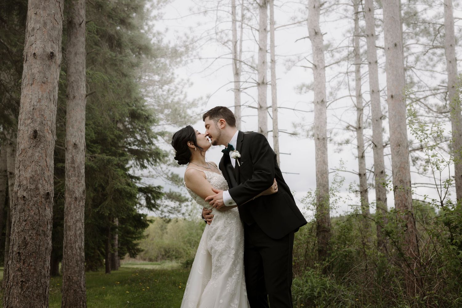A black and white blurred motion photograph of a couple walking together at an outdoor wedding ceremony.