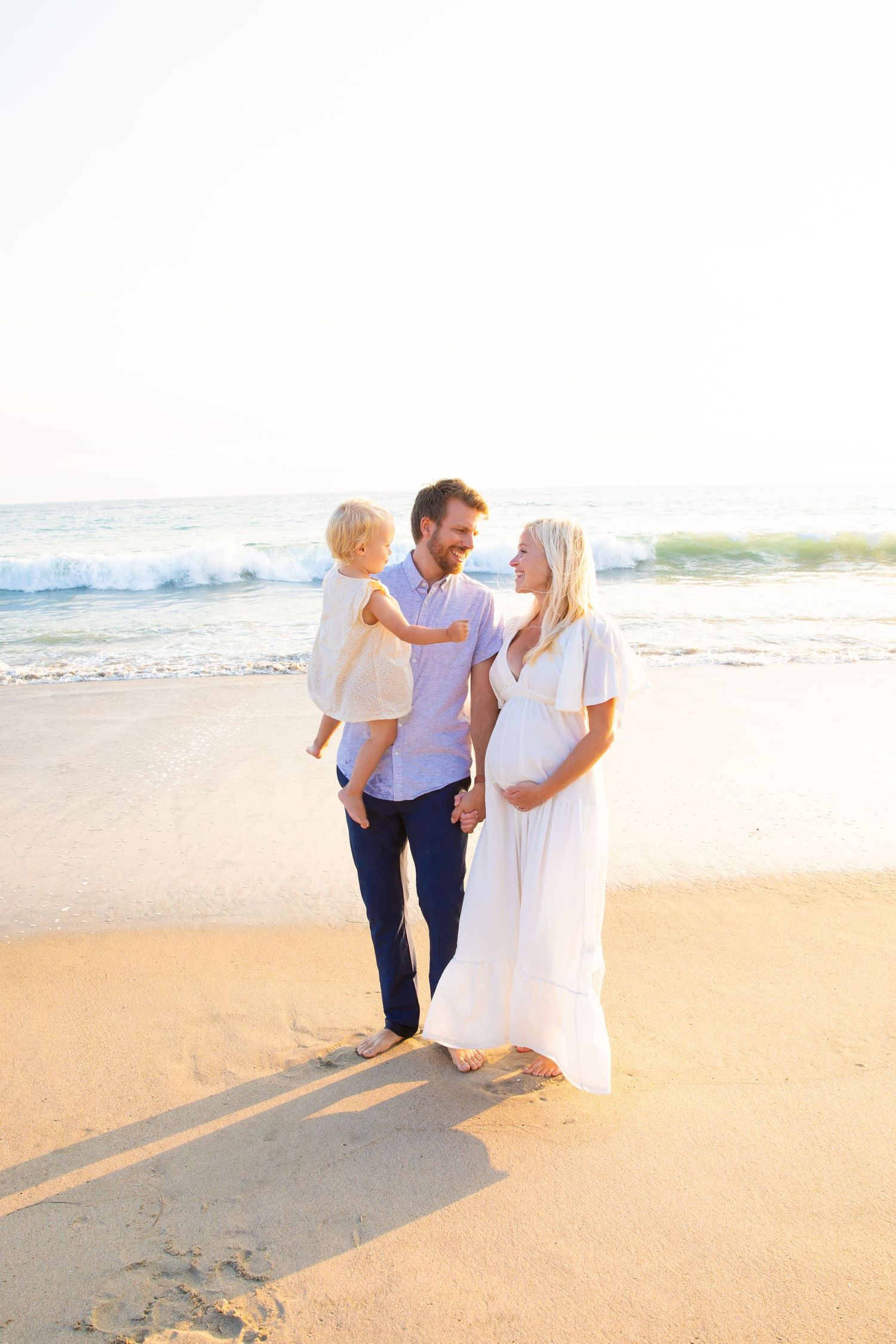 Tender moments captured in white showing gentle family interactions.