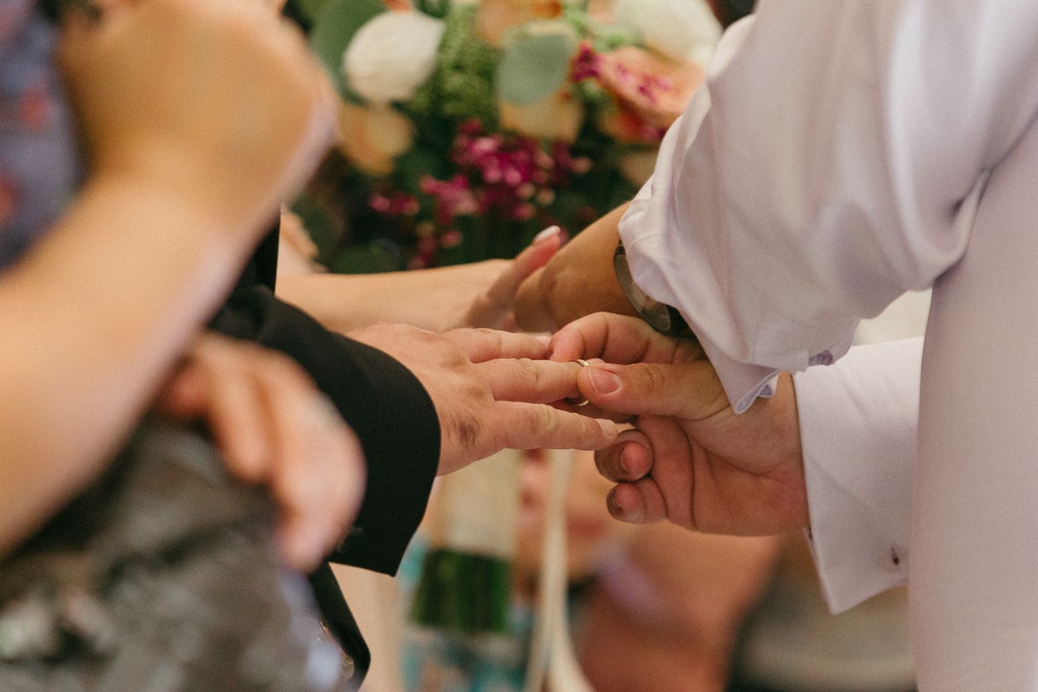 Close-up view of hands exchanging rings during a wedding in Cyprus.