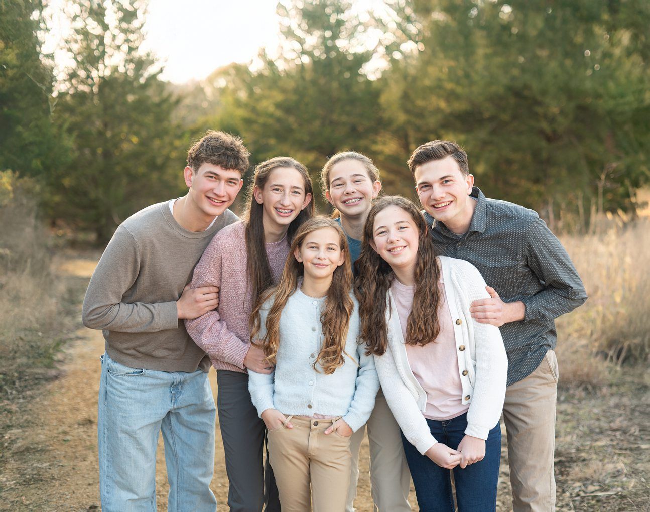 Family of 8 Portrait Session with Evergreens in Winter by Bartlesville Photographer Kristi Bray Photography