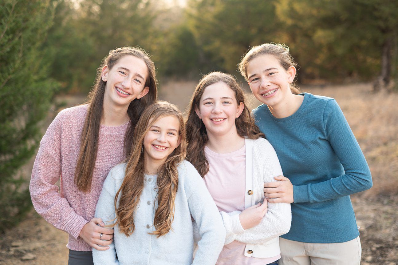 Family of 8 Portrait Session with Evergreens in Winter by Bartlesville Photographer Kristi Bray Photography