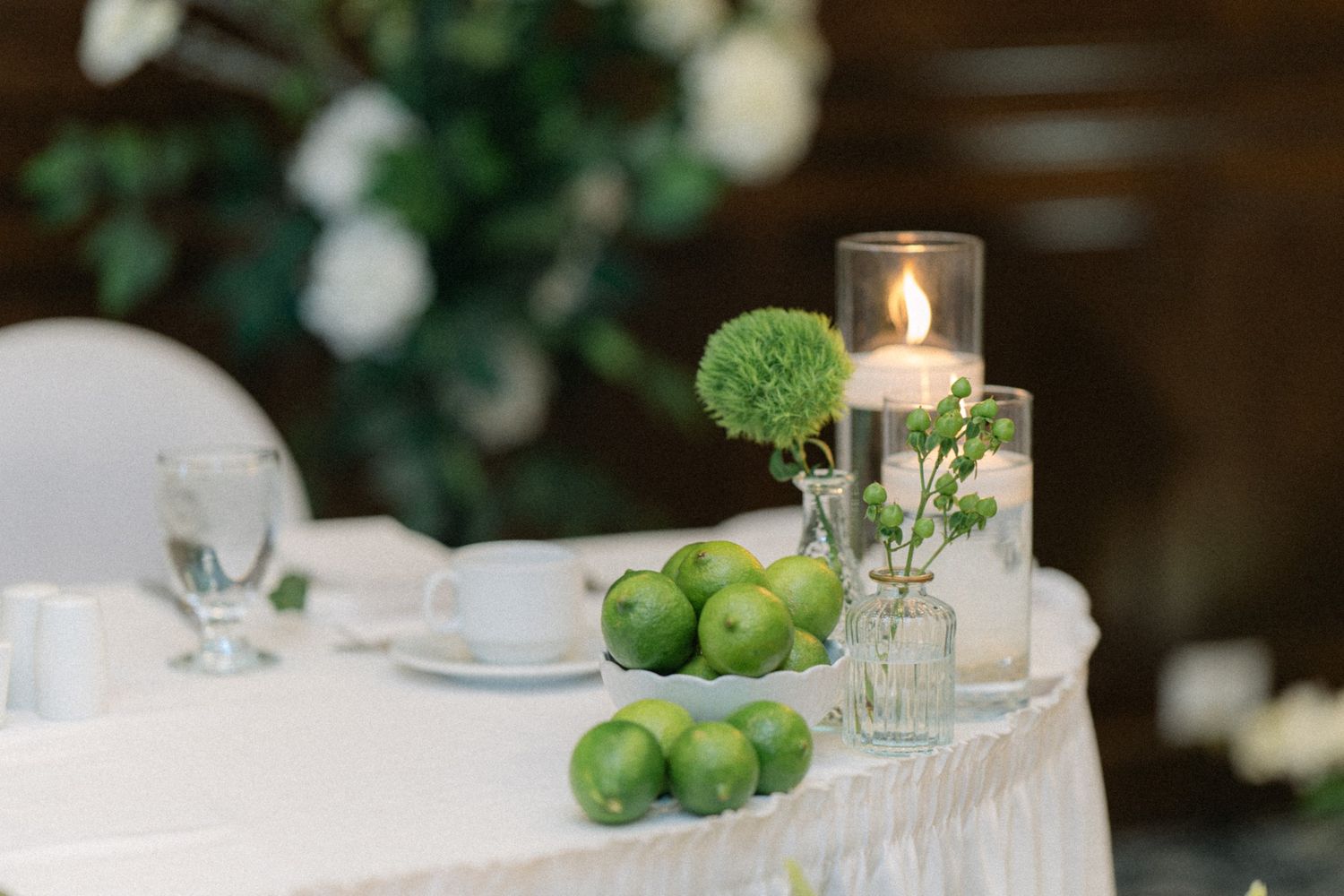 wedding details with glassware and fresh green citrus accents