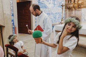 Candid moments with childrens from a wedding celebration with decorative blue tiles and floral details in the background.