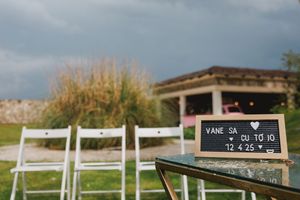 A panoramic view of a white fence stretches across rolling hills with a rustic wooden structure in the distance in a wedding in lisbon