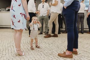 A sweet and funny child during a wedding celebration in Lisbon, on a patterned stone patio