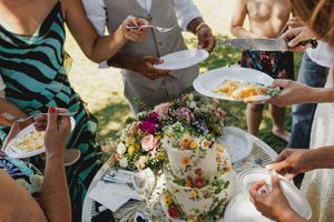People serving themselves cake at an outdoor wedding party in lisbon