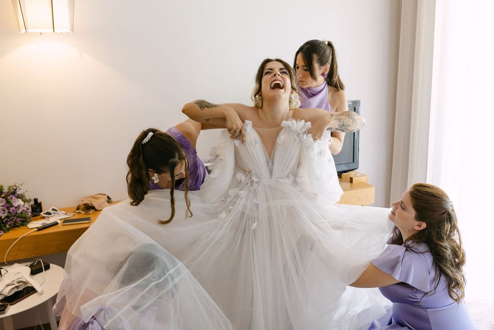 A series of photos showing a bride getting ready for her wedding with bridesmaids in a light-filled room.