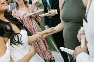 People enjoying a casual gathering with drinks and conversation at a wedding in Lisbon