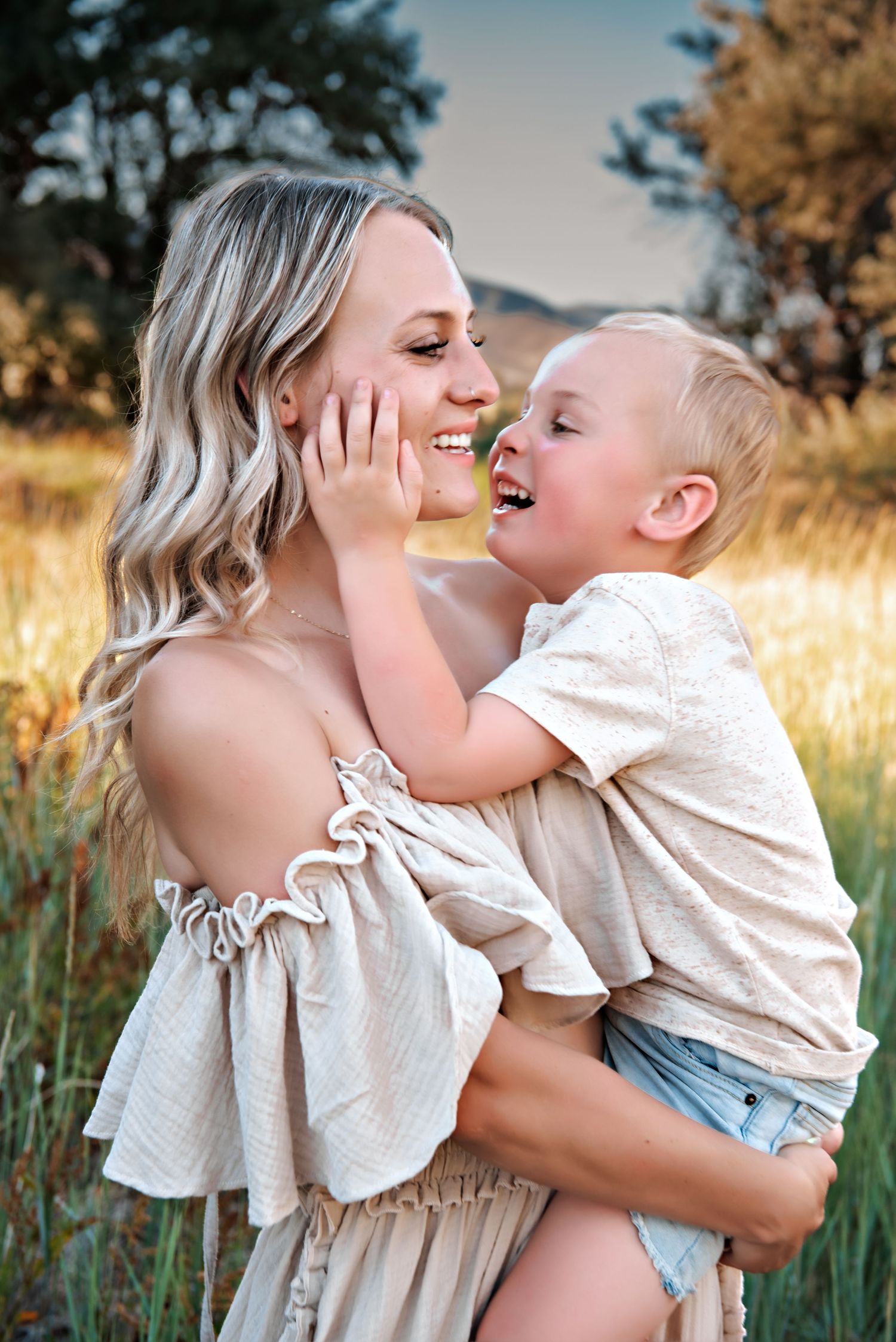 A tender moment shared between mother and child in a golden wheat field at sunset.
