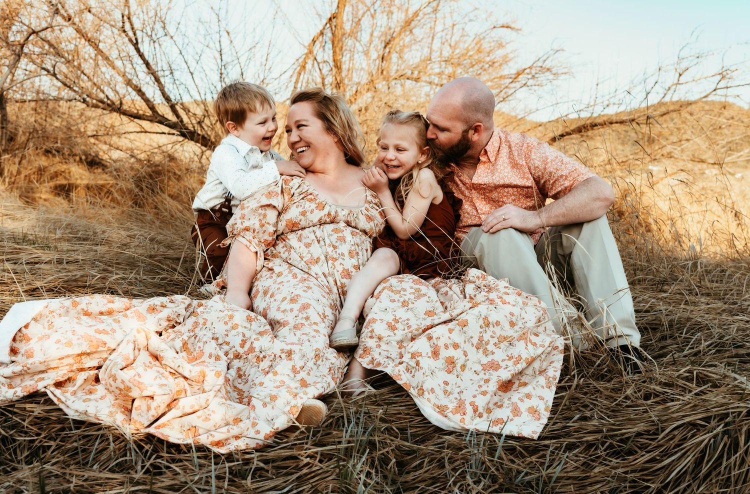 Casual family photo session in a rustic outdoor setting.