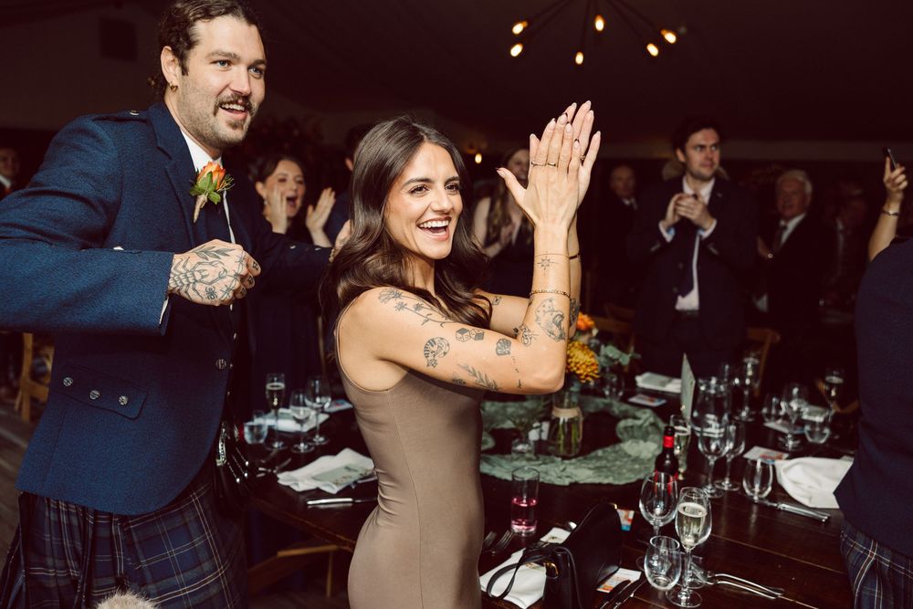 Candid photos of guests laughing and celebrating during a festive evening reception at a dimly lit venue.