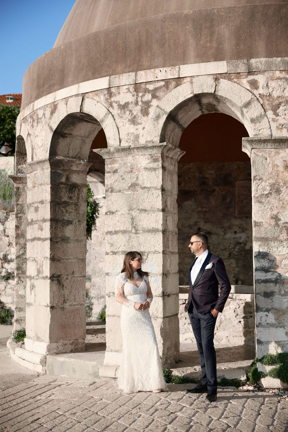 A historic stone archway structure creating an elegant architectural backdrop.