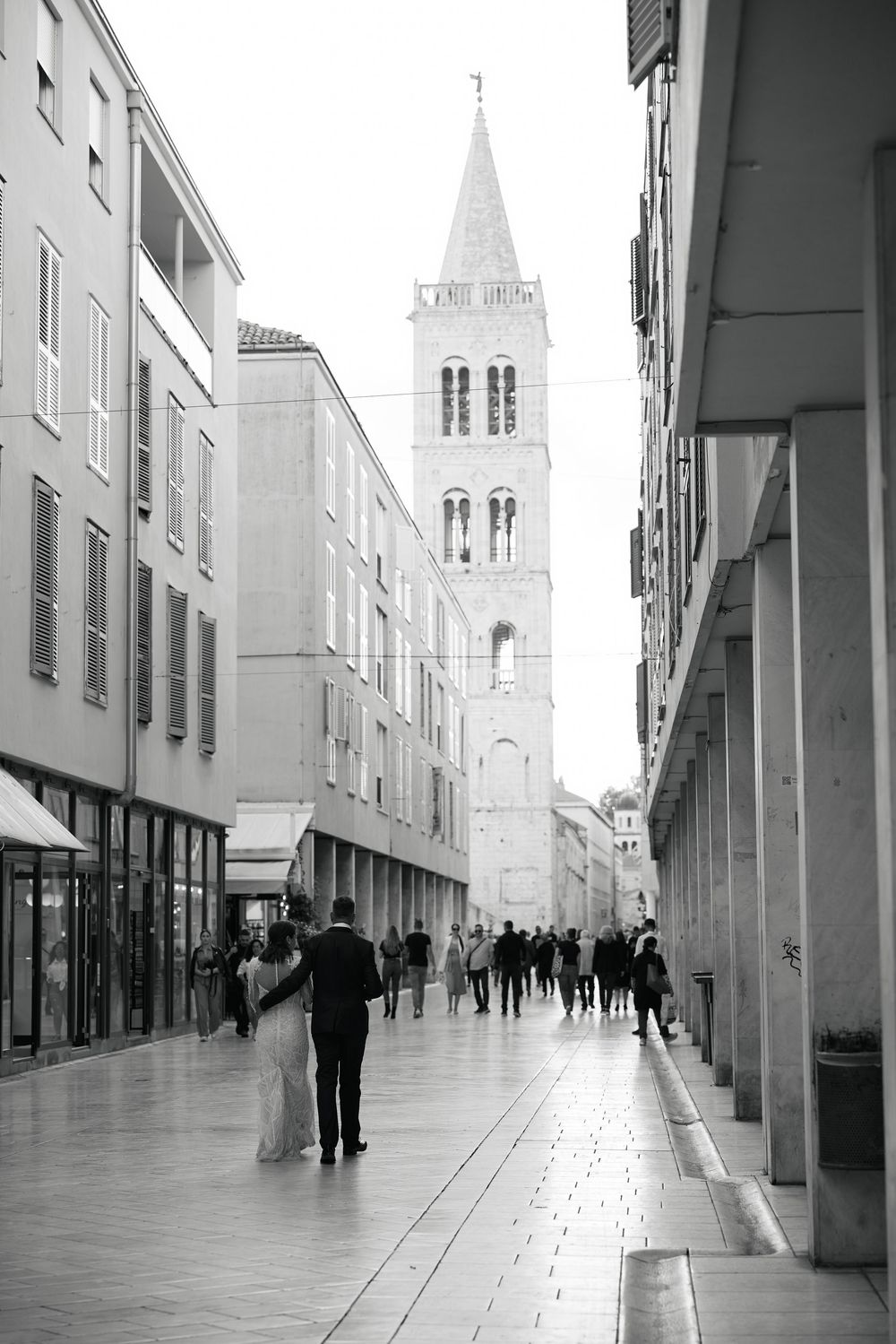 A black and white urban street scene with church spires and modern buildings creating strong architectural lines.