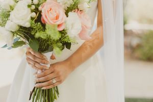 Elegant bridal bouquet featuring soft pink roses and white flowers with delicate greenery accents.