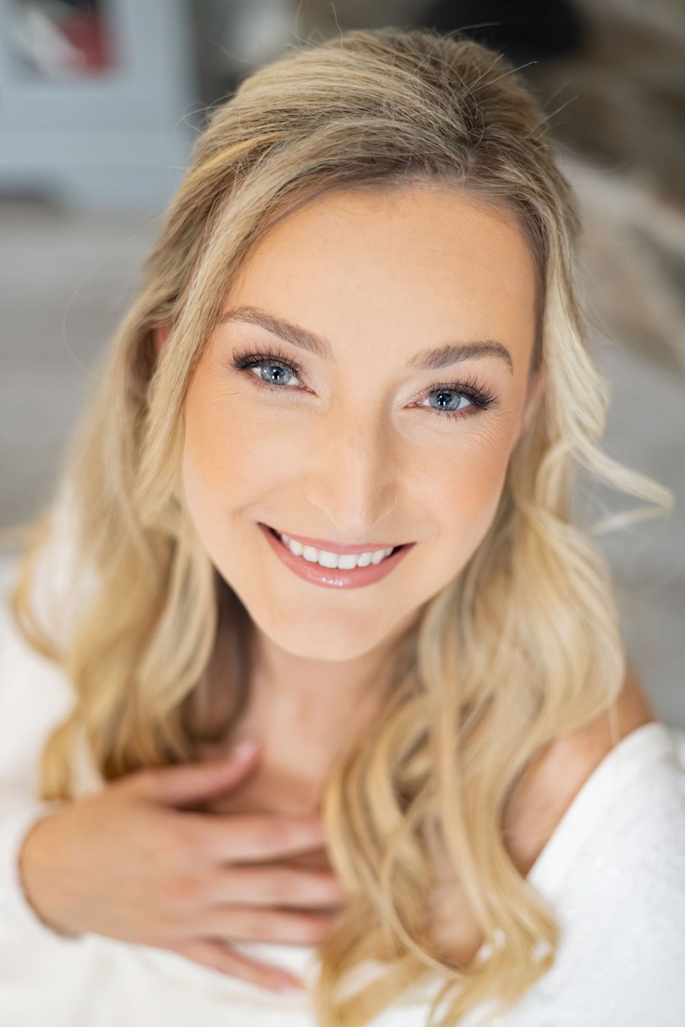 A series of close-up portraits showing bright smiles and blonde wavy hair against a light background.