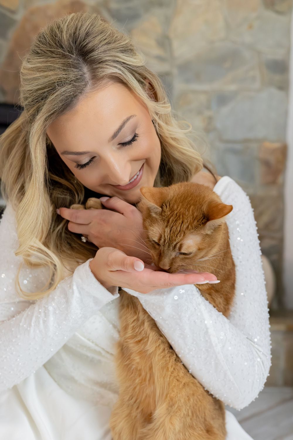 A person in a white sweater shares affectionate moments with their ginger cat in a series of tender photos.