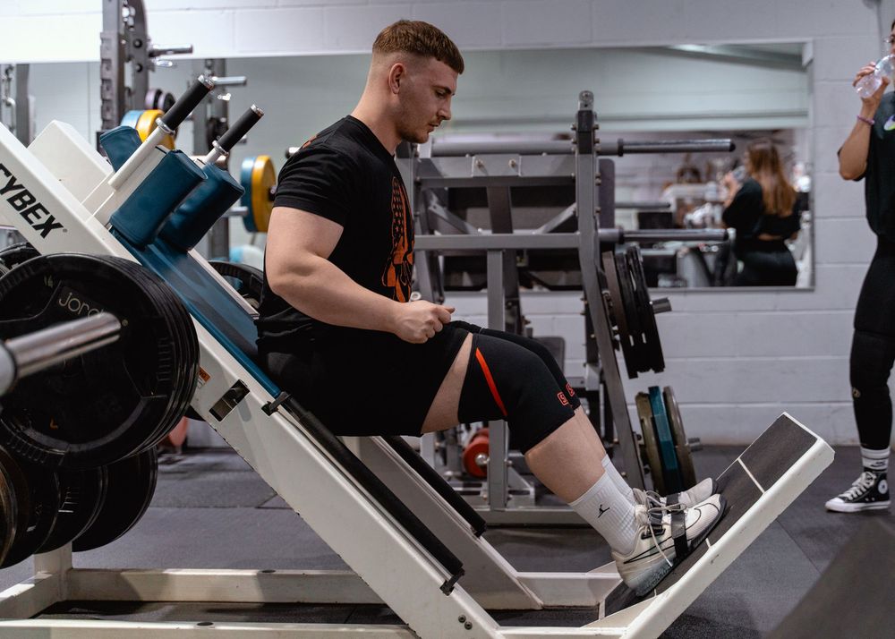 Weight training equipment and machines in a modern fitness facility interior.