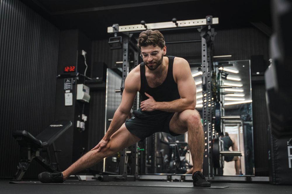 Fitness enthusiast doing bodyweight exercises in a modern gym facility.