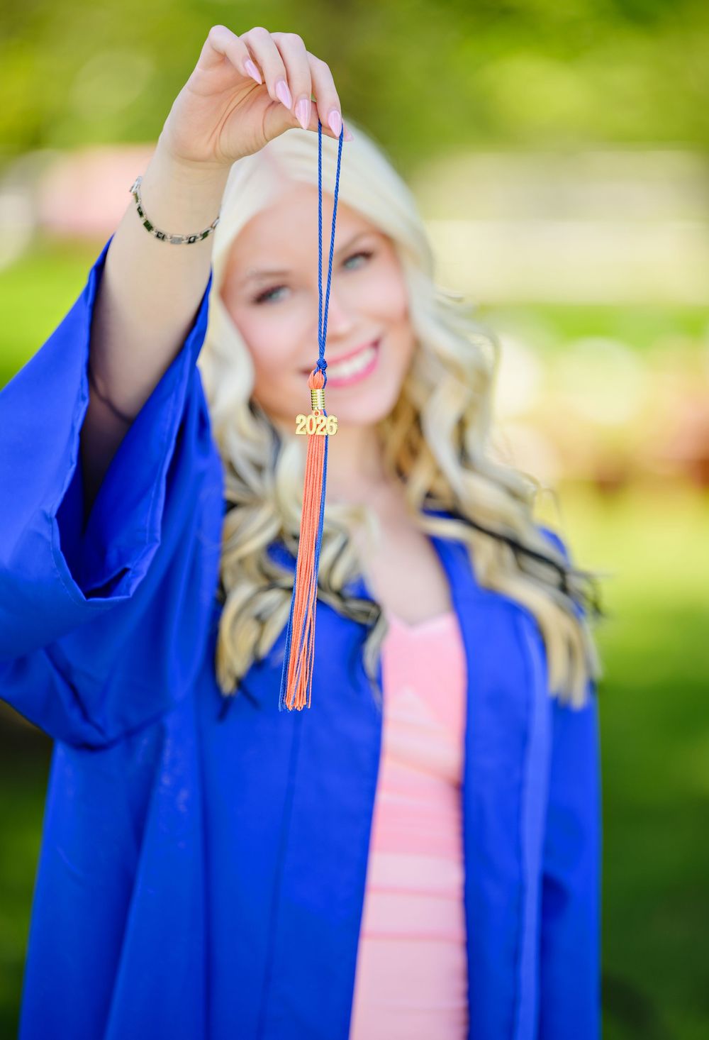 High school senior graduate showing off tassel in her cap and gown in Columbus Ohio before graduating