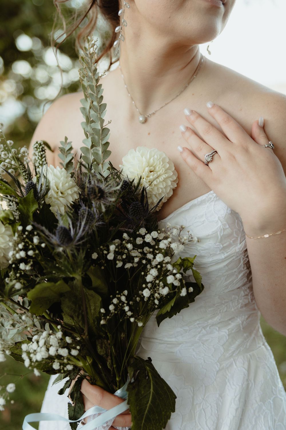 Wedding detail shot of bride with her flowers and new wedding band.