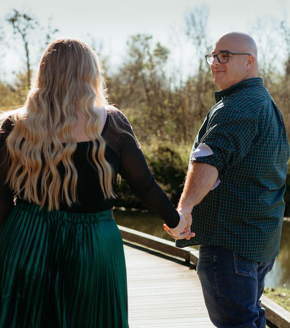 Lush greenery and sunlight set the perfect backdrop for a romantic couple photoshoot in Lakeland, Florida, showcasing love in nature