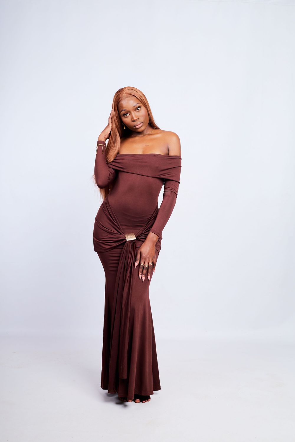 Fashion portraits in a flowing brown off-shoulder dress against white background.