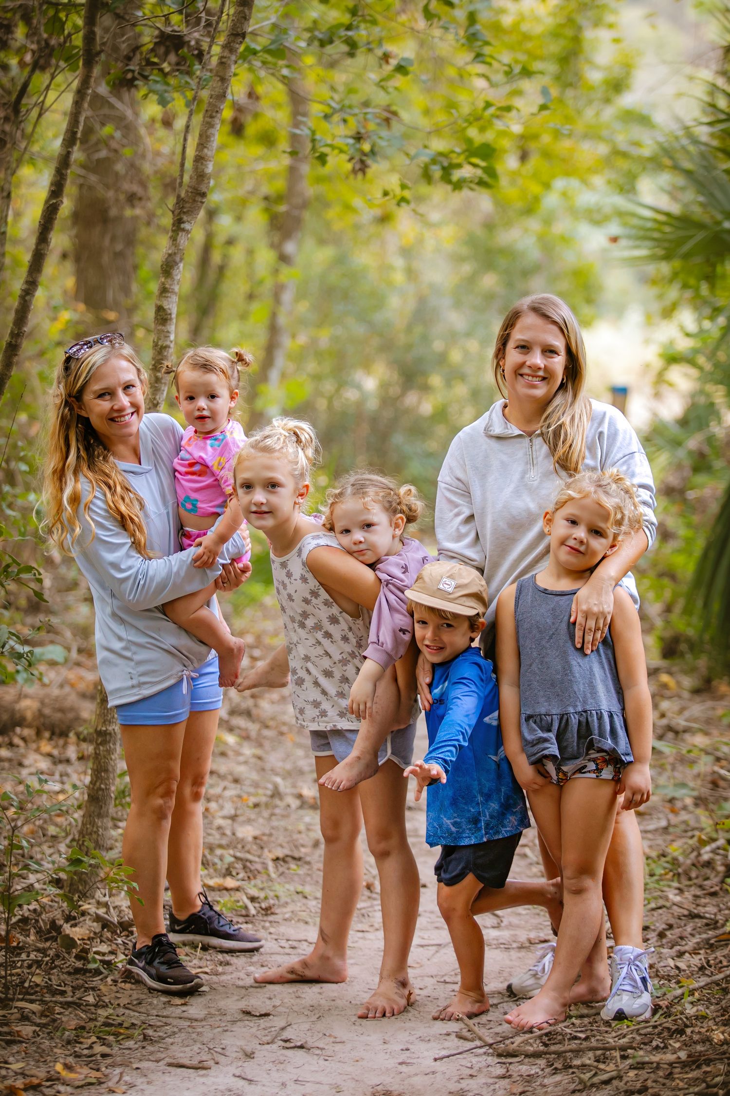 A group enjoying a casual outdoor adventure together on a wooded nature path.