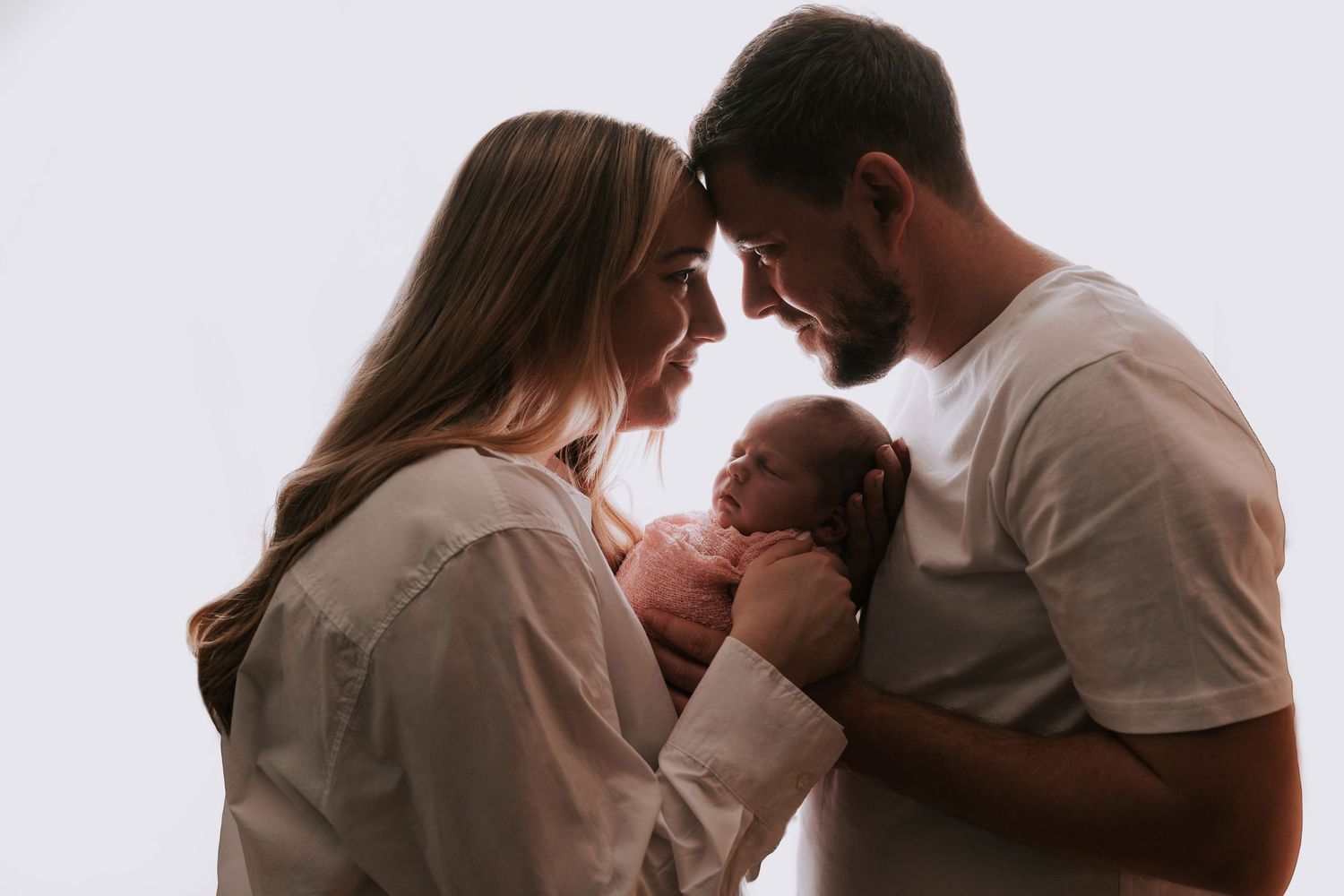 Newborn baby with parents during a heartwarming family studio photoshoot in Basildon, Essex