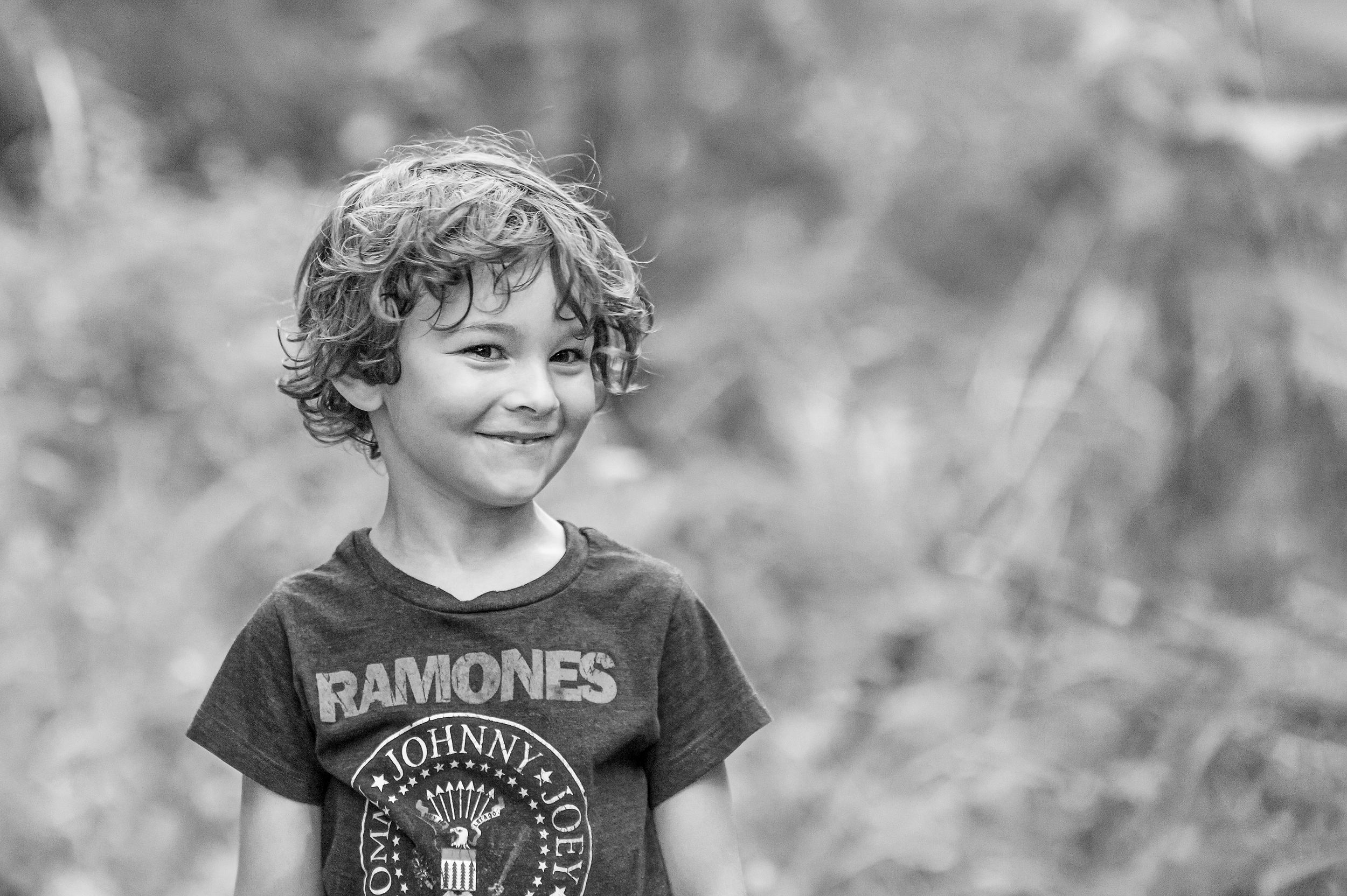 Black and white portrait wearing a Ramones t-shirt outdoors.