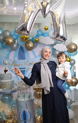 Festive blue and gold balloon display with silver letter balloons at a celebration party.