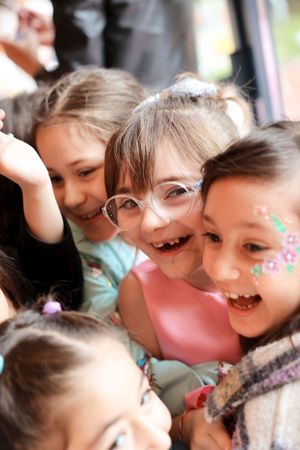 Close-up shot of excited children laughing and having fun at a birthday party.