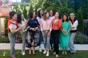 A group of friends gather outdoors posing together in casual attire for multiple group photos.