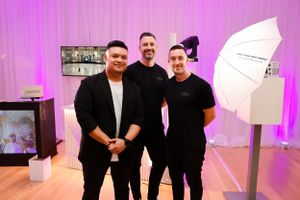 Photography setup at an event with lighting equipment and purple backdrop.