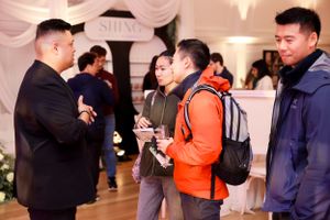 Small group engaged in conversation at an indoor networking event.