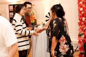 Event attendees interacting and networking in a bright indoor venue.