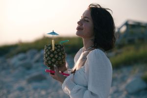 Enjoying the refreshing fruit juice by the beach.