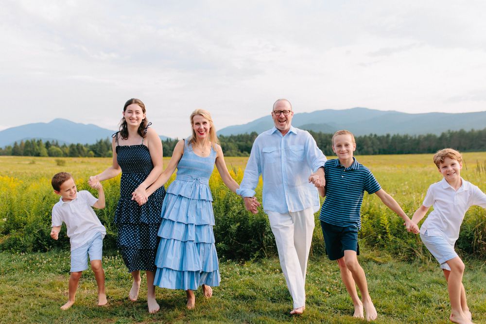 Candid family moments captured against a backdrop of rolling hills and vibrant yellow canola fields.