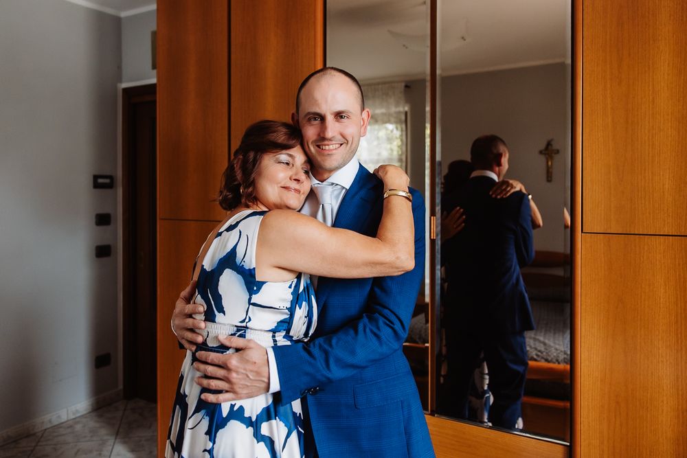 A sequence of four photos showing a couple hugging and embracing in a modern interior space.