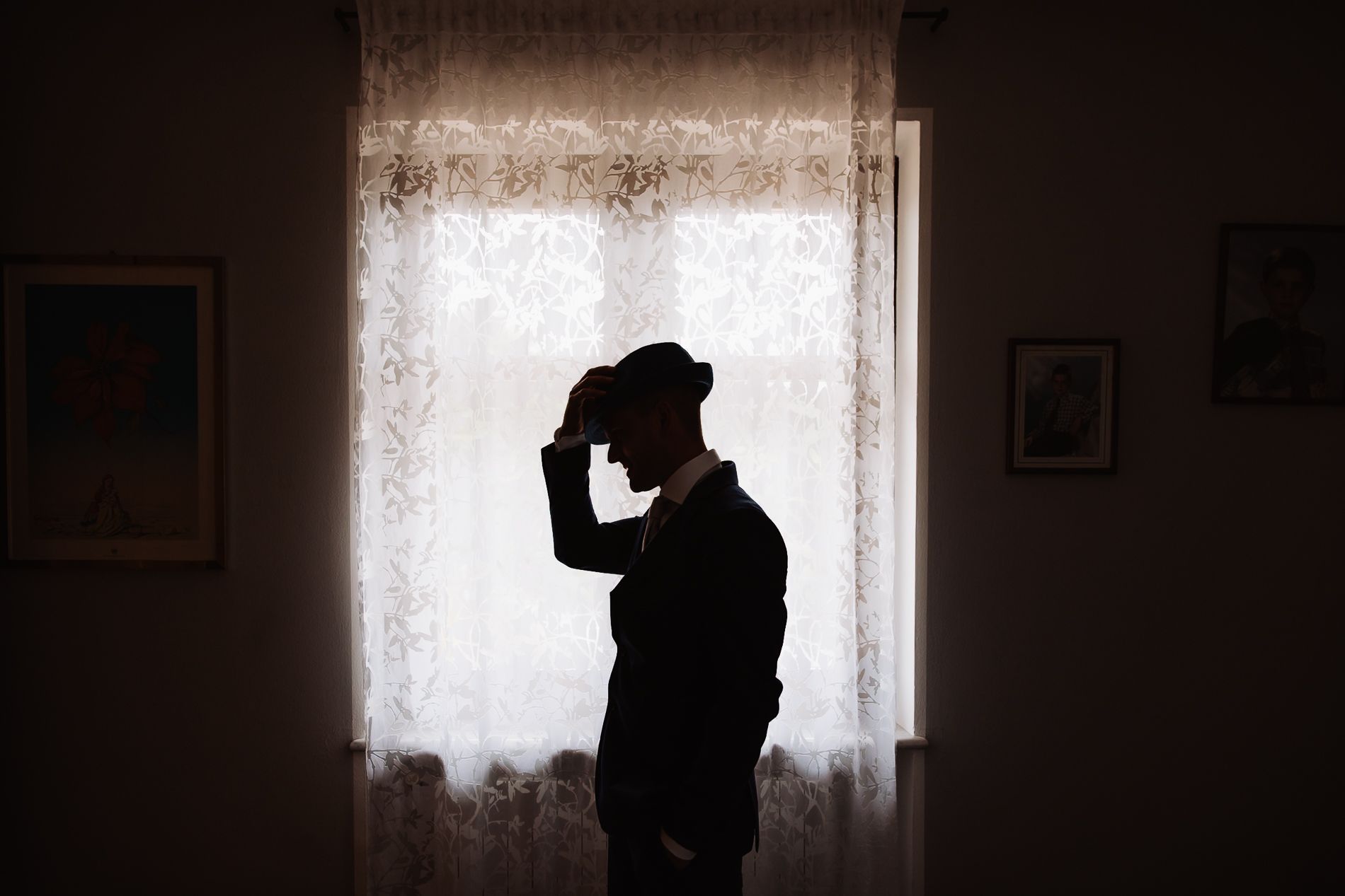 Silhouetted figures in dark atmospheric scenes against window light create a moody, cinematic look.