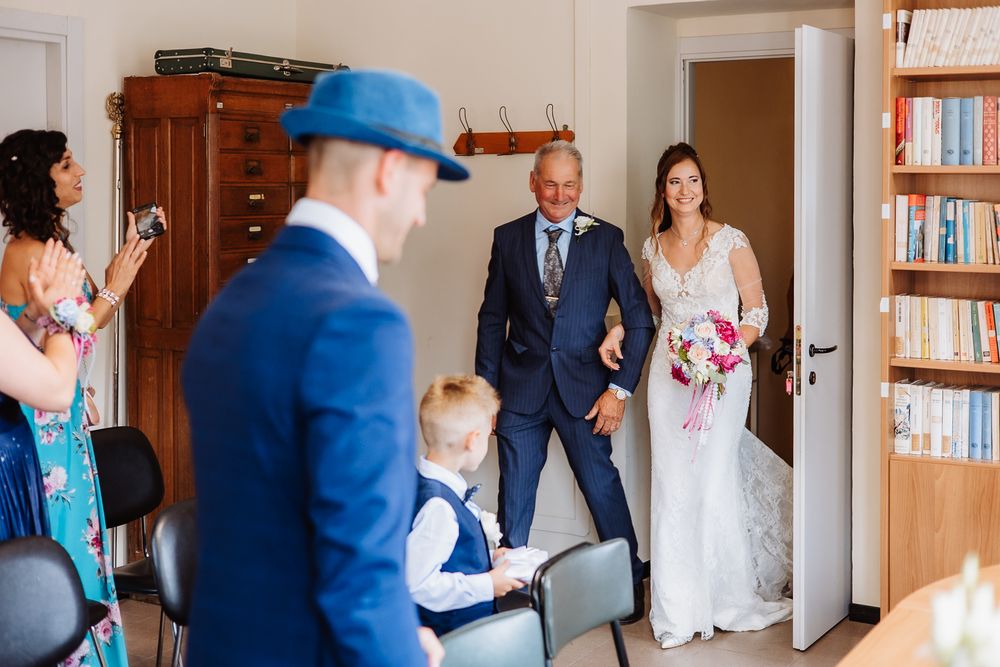 Multiple wedding party reactions and candid moments of guests in a hallway during a photo session.