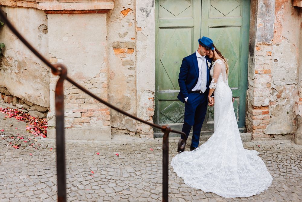 A romantic wedding photo series showing couple posing together against rustic stone walls and doorways.