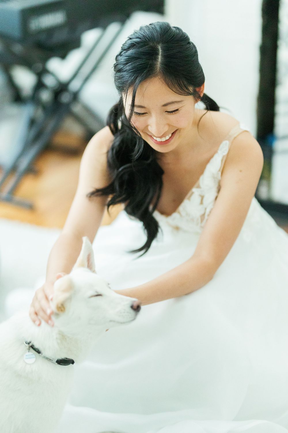 A joyful moment in a white wedding dress with a furry companion sharing an intimate connection.