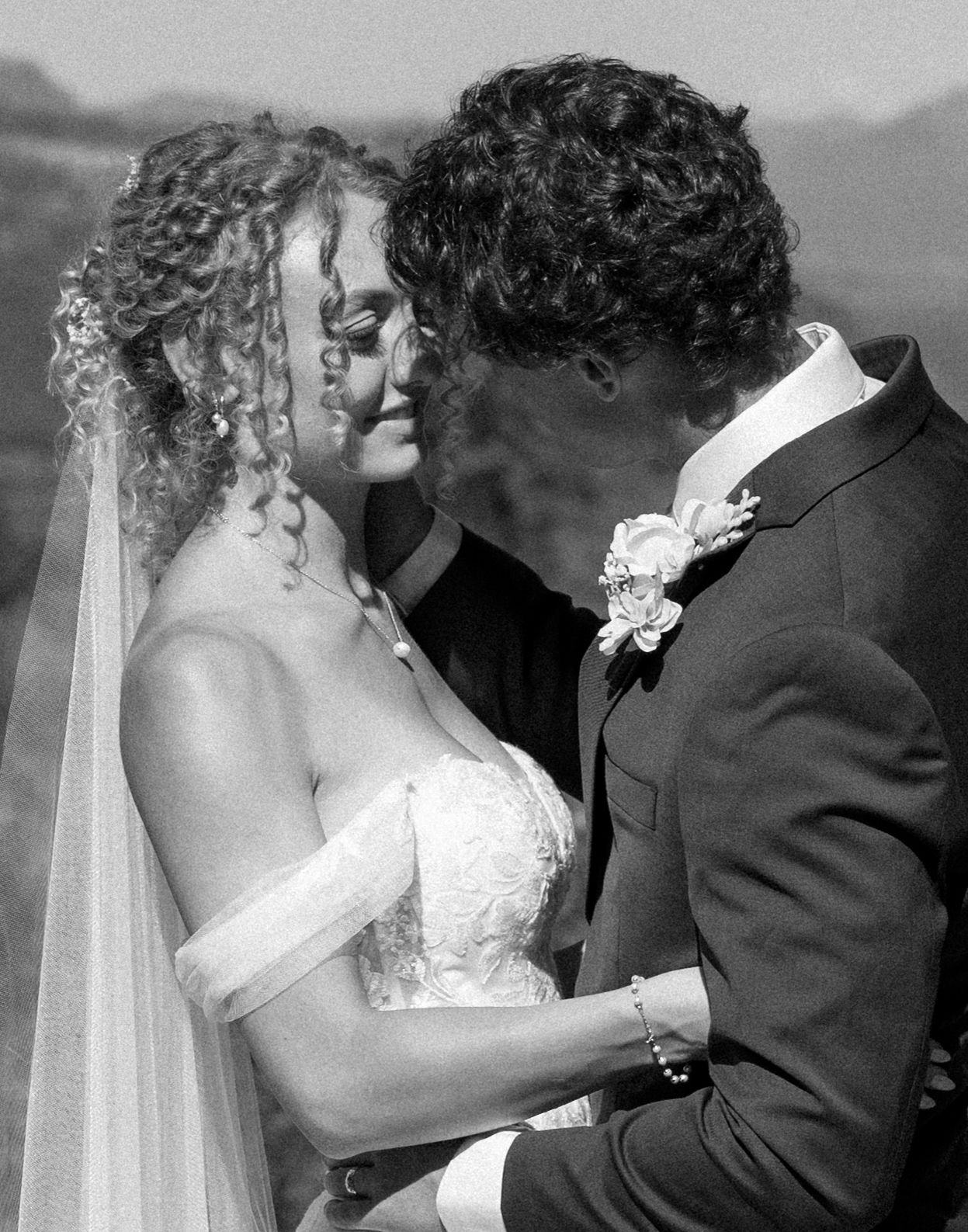 A romantic sequence of black and white photos showing newlyweds sharing tender kisses during their wedding celebration.