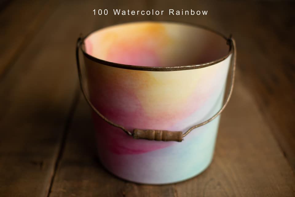 Watercolor rainbow painted metal bucket with wooden handle photography prop.