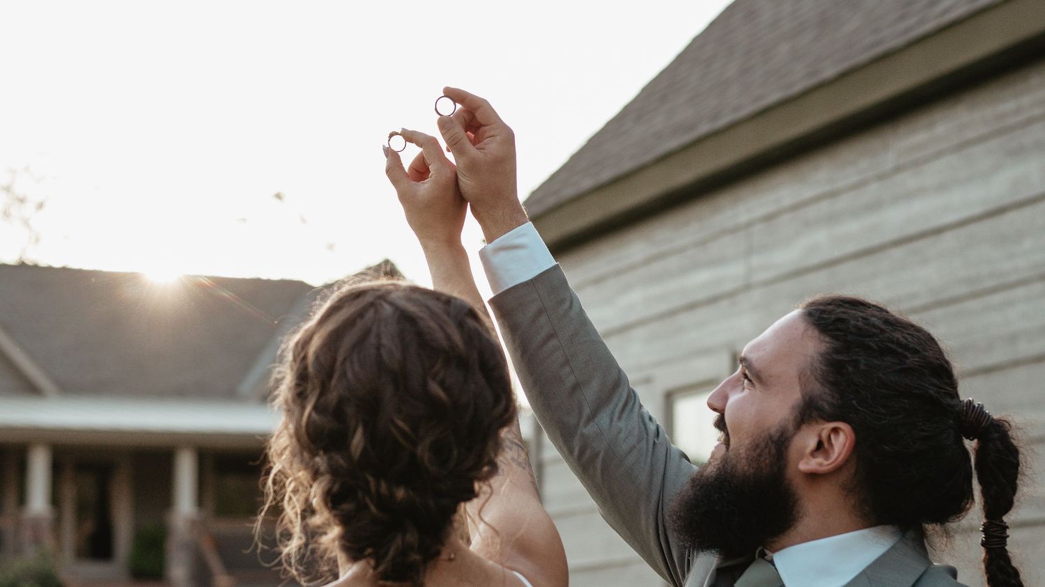 A series of black and white candid photos show tender romantic moments between a couple at sunset outdoors.