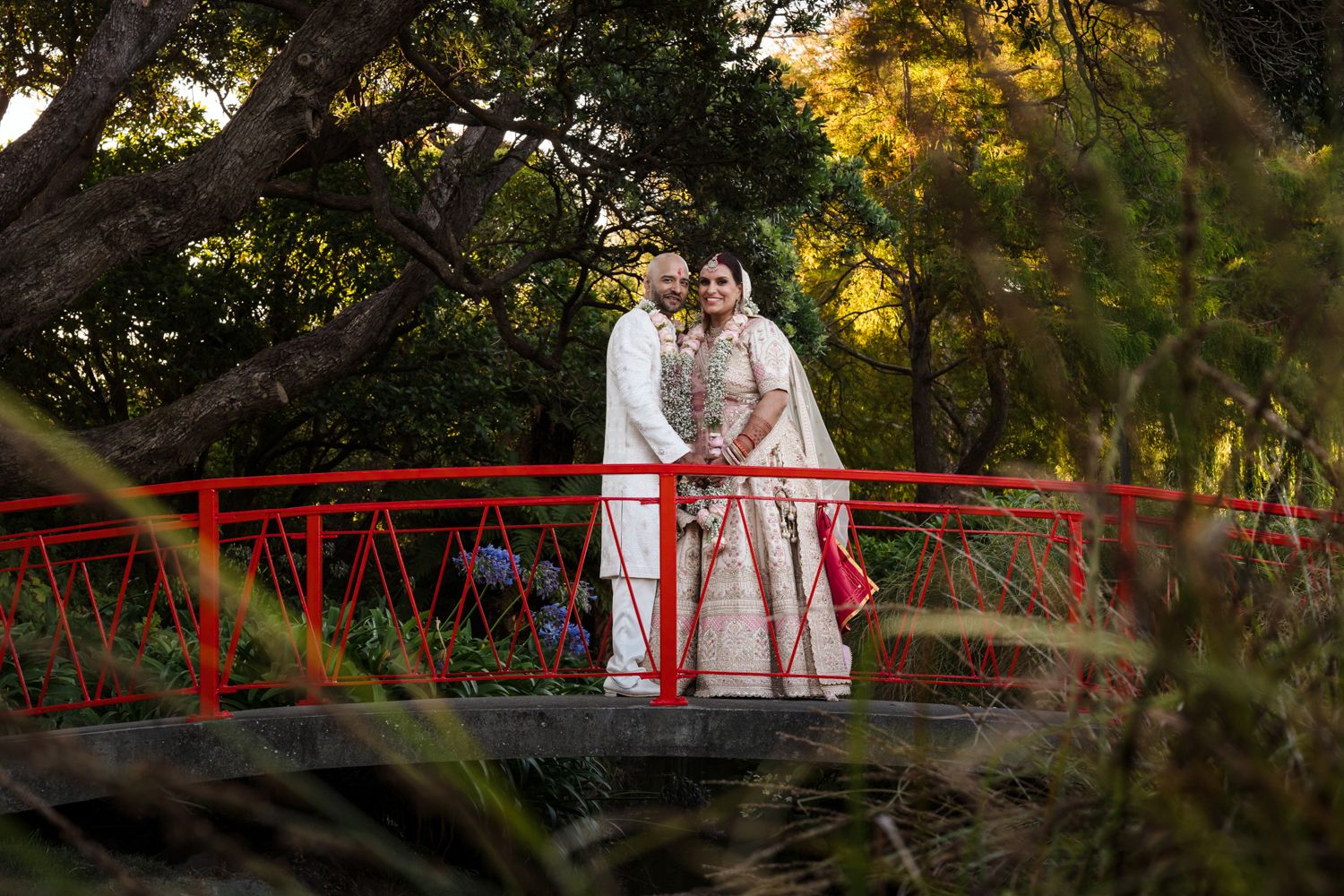couple looking at camera and smiling during their couple session after wedding at lowerhutt events center in Wellington