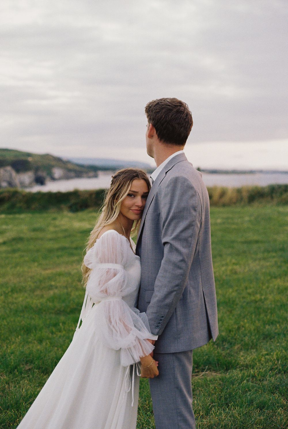 Couple eloping at Dunluce Castle in Northern Ireland hugging