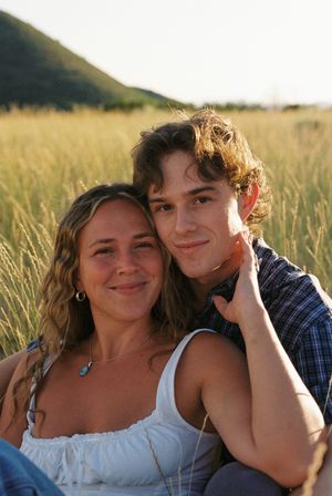 Couple sitting in a field on film at zion national park