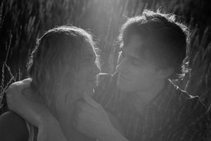 Couple sitting in the grass during engagement session on film at zion national park